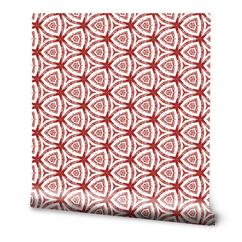 Wallpaper with geometric red and white pattern featuring repeating triangular floral shapes