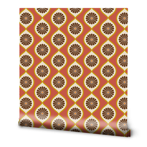 A roll of retro wallpaper with a geometric floral pattern in orange, brown, and white colors.