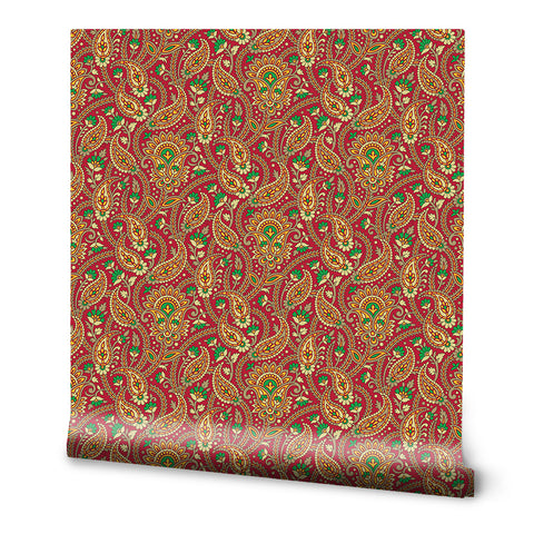 Wallpaper with traditional paisley pattern in red, gold, and green colors on a decorative background