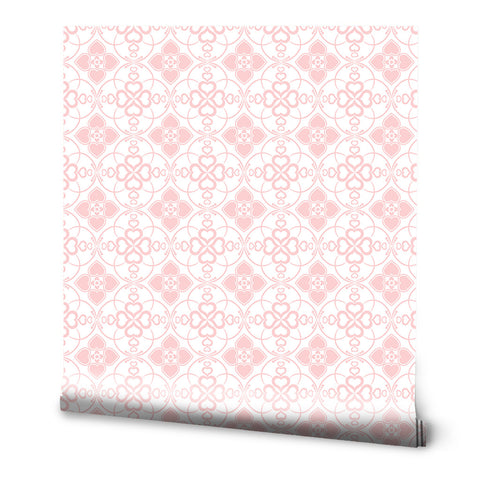 Pink and white wallpaper with a repeating heart and floral motif arranged in circular geometric patterns, suitable for bedrooms or children’s rooms.