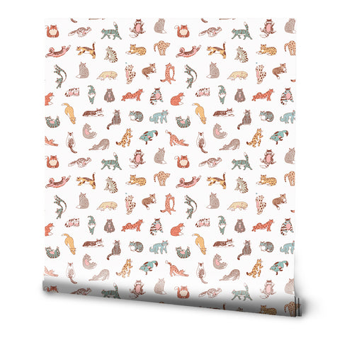 A roll of removable wallpaper with a pattern of various cartoon cats in multicolor on a white background.