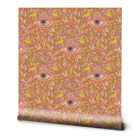 A roll of wallpaper with a pattern featuring geometric shapes and eyes in a bohemian style.