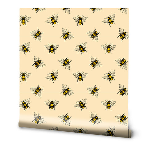 A roll of removable wallpaper with a pattern of yellow bees on a beige background.