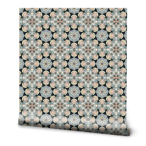 Wallpaper with kaleidoscope-inspired geometric pattern in beige, blue, and black star motifs