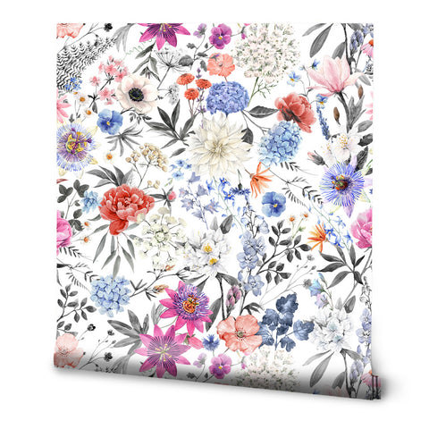 Floral wallpaper with multicolor blooms in pink, blue, purple, orange, and white, accented by black and gray leaves on a white background, in a botanical illustration style.