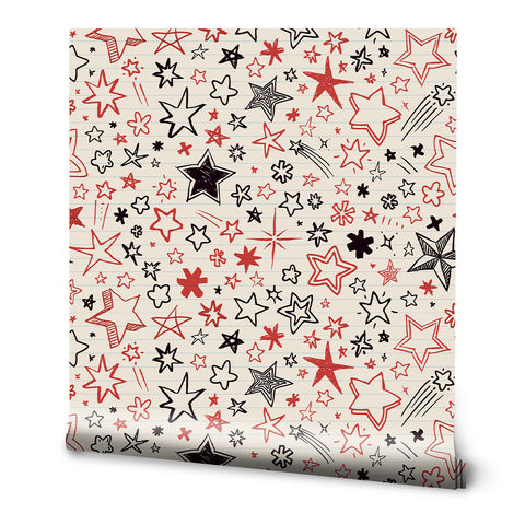 A roll of wallpaper with a white background covered in red and black doodle-style stars.