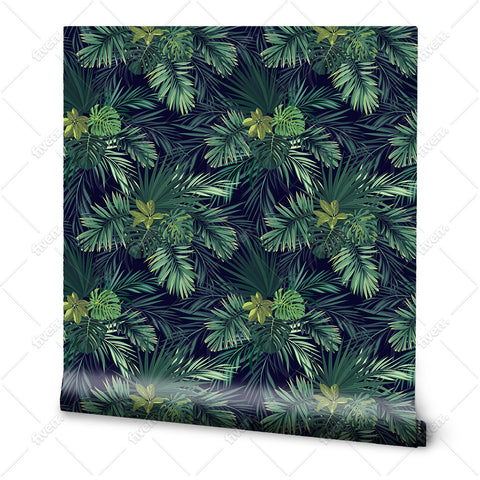 A roll of wallpaper featuring a tropical palm leaf pattern with predominantly dark green leaves on a black background.