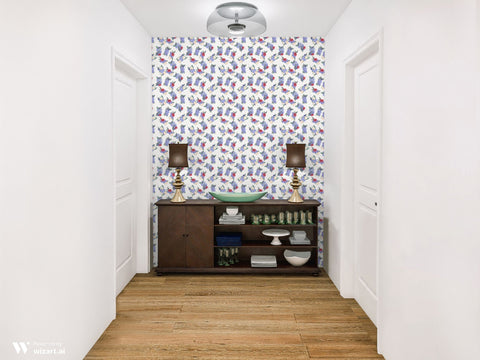 Floral wallpaper with purple, red, and cream flower bouquets displayed on an accent wall in a hallway with white walls and wood floors.