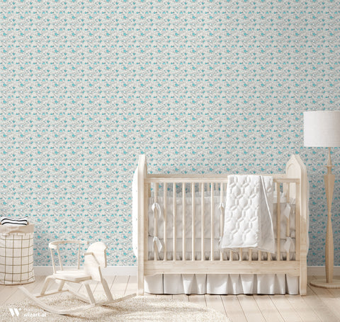 Gray wallpaper with turquoise cartoon birds, hearts, and whimsical line details displayed in a bright nursery with natural wood furniture.