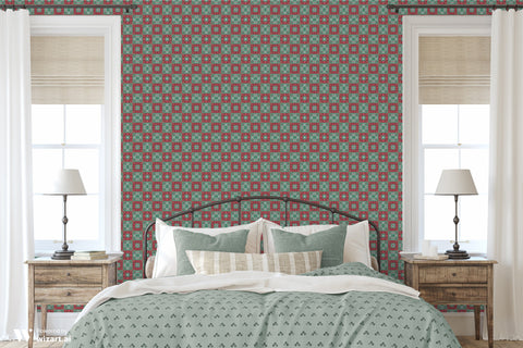 Bedroom interior with red and teal geometric patterned wallpaper behind the bed