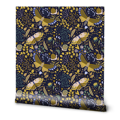 A roll of wallpaper featuring a floral and nighttime garden pattern with gold, navy, and green colors.