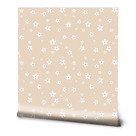 A roll of beige floral wallpaper with small white daisy patterns spread evenly across the surface.