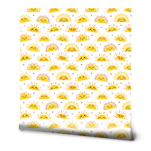 A roll of removable wallpaper with a pattern of smiling sun faces and hearts in yellow, orange, and white colors.