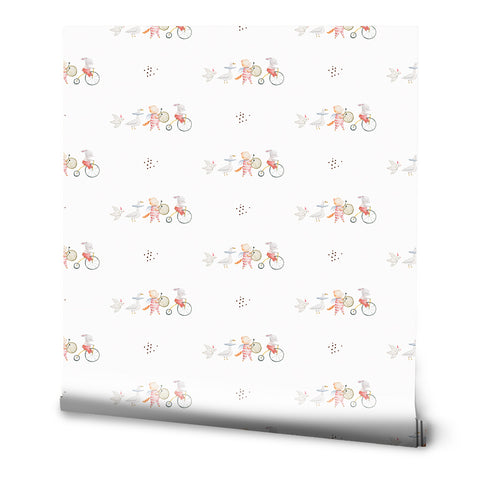 A roll of circus-themed wallpaper with a pattern featuring clowns, bicycles, and stars.