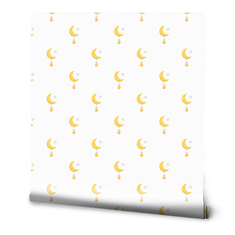 White wallpaper with a simple crescent moon, star, and hanging orb pattern in soft yellow and gold tones.