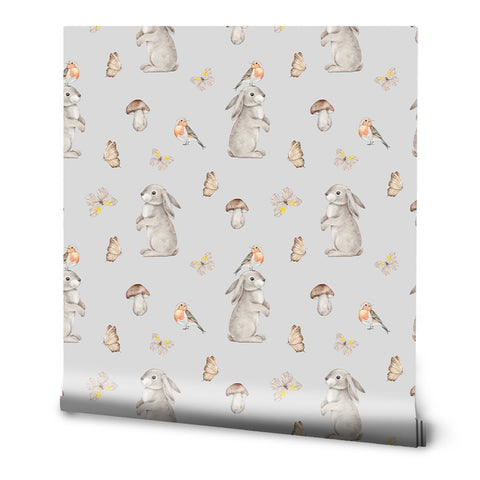 A roll of removable wallpaper with a pattern of rabbits, butterflies, and mushrooms in a neutral color palette.