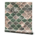 Wallpaper with geometric quatrefoil pattern in green, beige, and gray stone texture