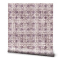 Roll of wallpaper with abstract web-like purple floral pattern on beige background
