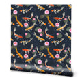 A roll of removable wallpaper with a serene koi pond design, featuring colorful fish and pink lotus flowers against a dark background.