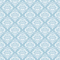 Blue wallpaper with a repeating white damask motif, creating a traditional and elegant look for bedrooms or living areas.