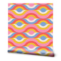 A roll of retro wallpaper with a colorful, psychedelic wave pattern.