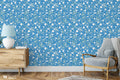  floral wallpaper with a blue background and white daisy patterns.