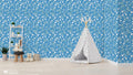  floral wallpaper with a blue background and white daisy patterns.