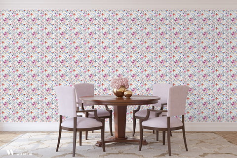 Floral wallpaper with pink, blue, orange, and white flowers on a white background, shown in a dining room with a round wooden table and pastel chairs.