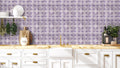 Kitchen with abstract purple floral wallpaper, white cabinets, wooden countertop, and gold faucet
