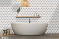 
Blue and white floral wallpaper in a contemporary bathroom with freestanding tub and natural decor accents