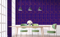 Dining room with dark blue wallpaper and gold damask pattern behind wooden table and green chairs