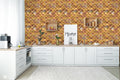 Modern kitchen with white cabinets and wooden countertop against wallpaper featuring geometric quatrefoil pattern in gold, orange, and brown stone texture