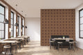 Restaurant interior with feature wall covered in brown and beige geometric diamond patterned wallpaper