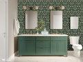 Bathroom interior with a dark green damask wallpaper featuring beige and gold floral motifs, paired with a green vanity, double mirrors, gold fixtures, and a white toilet.