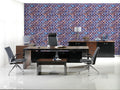 Modern office with wooden desk and black chairs against wallpaper featuring geometric lattice pattern in blue, bronze, and purple on navy background