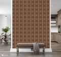 Hallway interior with brown and beige diamond patterned wallpaper, wooden bench, and decorative throw