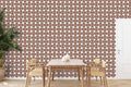 Dining area with wallpaper featuring red, brown, and green paisley-inspired floral patterns on a white background