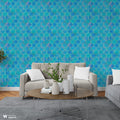 Living room wall with blue quatrefoil-patterned wallpaper in turquoise and navy tones, behind a beige sofa and modern coffee table.