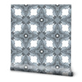 Gray geometric wallpaper with star and diamond motifs on a white background, featuring a watercolor texture effect.