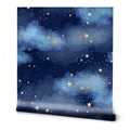 A roll of removable wallpaper featuring a pattern of stars and clouds on a blue background.