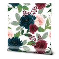 Watercolor floral wallpaper with navy, burgundy, and blush pink roses and green leaves on a white base, suitable for living rooms or bedrooms.