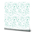 Light teal scroll-patterned wallpaper on a white background with a delicate vine design.
