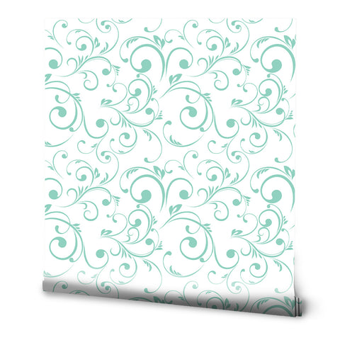 Light teal scroll-patterned wallpaper on a white background with a delicate vine design.